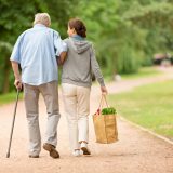 senior-and-carer-walking-slowly