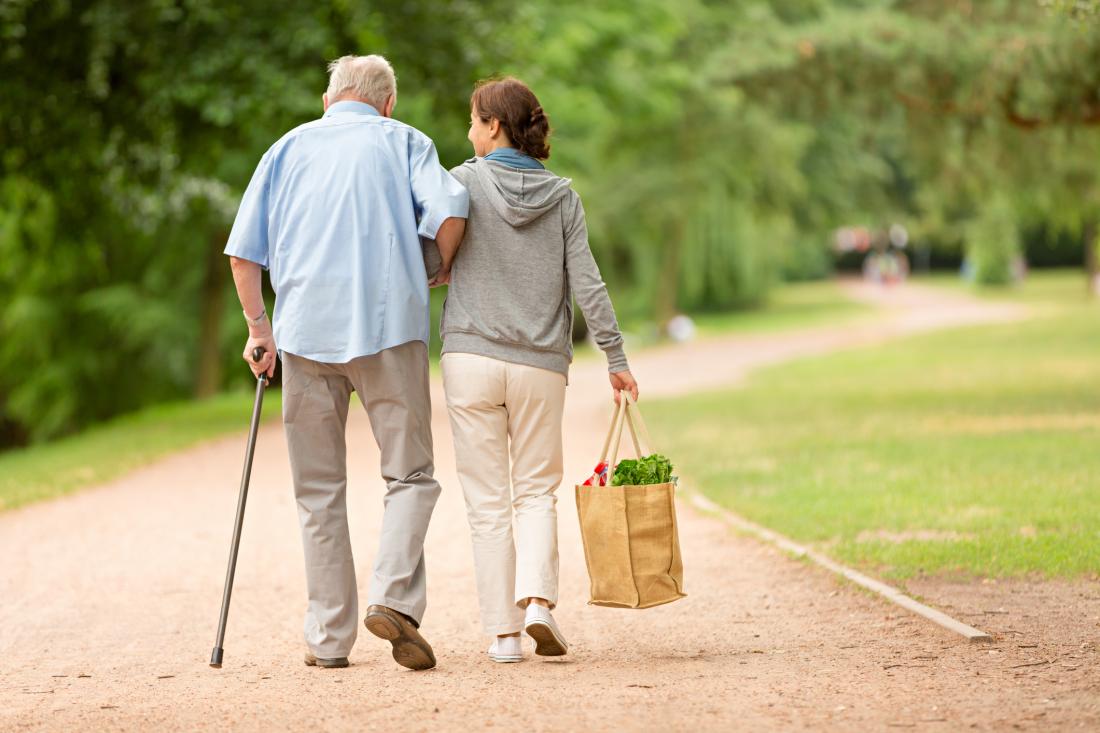 senior-and-carer-walking-slowly.jpg